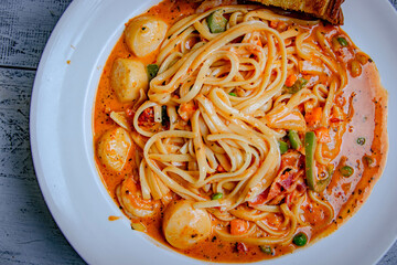 Top view of Seafood pasta with shrimps and clams in a red sauce.