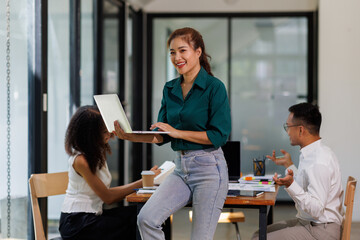 Obraz premium Team of confident business people point to graphs and charts to analyze market data, balance sheet, account, net profit to plan new sales strategies to increase production capacity. 