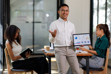 Team of confident business people point to graphs and charts to analyze market data, balance sheet, account, net profit to plan new sales strategies to increase production capacity.	
