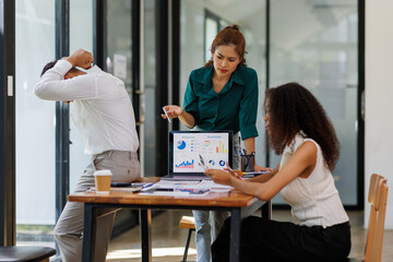 Fototapeta premium Team of business Asian work with documents tax laptop computer in office. Sad, unhappy, Worried, Depression, or employee life stress concept 