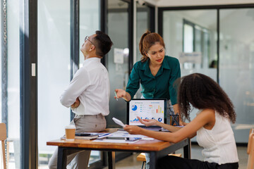 Team of business Asian work with documents tax laptop computer in office. Sad, unhappy, Worried, Depression, or employee life stress concept
