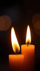 Close-up of two candle flames overlapping, creating a warm, flickering light, shadow, mystical