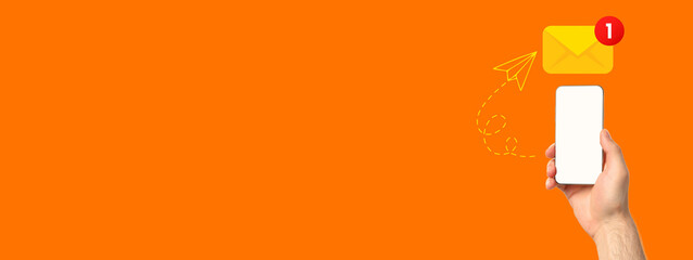 Hand holds smartphone displaying notification for a new message on vibrant backdrop