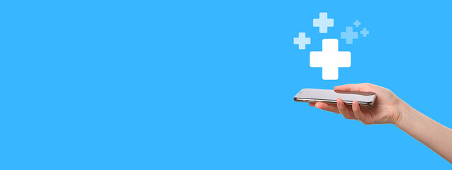 A hand holds a sleek mobile device with health graphics on a blue background