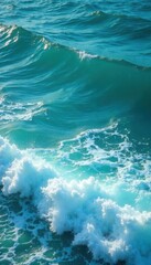 Ocean waves with foam breaking on turquoise blue water surface, foamy sea, sea foam