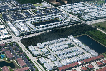 Obraz premium Suburban neighborhood top view. Suburban township. Aerial landscape. Landscape of residential neighborhood. Suburban neighborhood of town aerial view. Aerial neighborhood in town. Luxury district