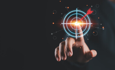 Businessman hand touching to target dart board for setup and achievement objectives target for...