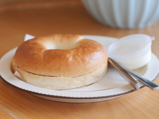 Bagel with cream cheese. Classic Baked Bagel bread serving on the plate. Famous quick and easy flour breakfast menu in restaurant.