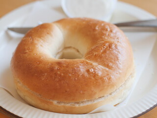 Bagel with cream cheese. Classic Baked Bagel bread serving on the plate. Famous quick and easy flour breakfast menu in restaurant.