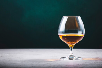 French cognac Superior in snifter glass on dark green background