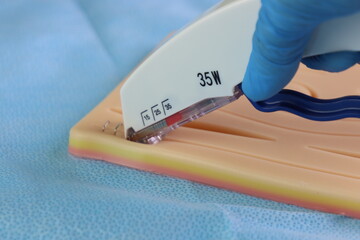 Professional wearing glove training stapling with a simulated suture model and using surgical staple