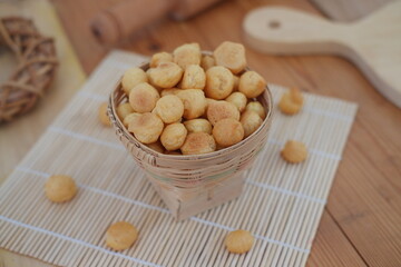 a woven bamboo basket filled with small, round cheese puffs or savory snack balls