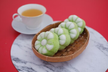 The cakes are flower shaped and beautifully colored in light green and white, giving them a fresh, appealing look
