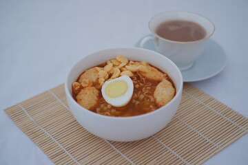 a warm and comforting bowl of instant noodles served in a white bowl