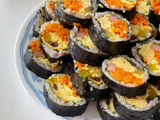 Korean Seaweed Rice Rolls or Kimbap Korean dish made from cooked rice vegetables, meats that are rolled in seaweed, BBQ Kimbap Korean food Isolate on white with clipping path.