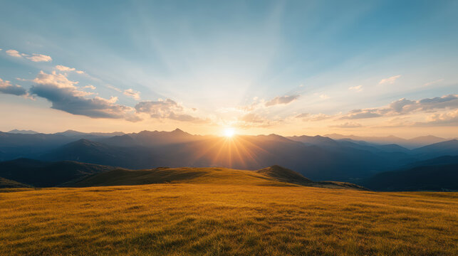breathtaking sunset illuminates mountain range, casting golden rays over grassy landscape