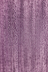 texture of valuable wood. wooden purple board. lumber. koto, African, Pterygota, view from above. vertical texture