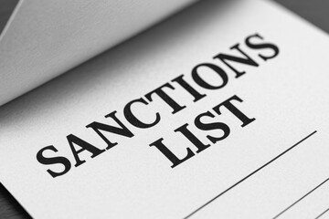Fototapeta premium Sanctions list document highlighting trade barriers and concept of regulatory compliance in international relations