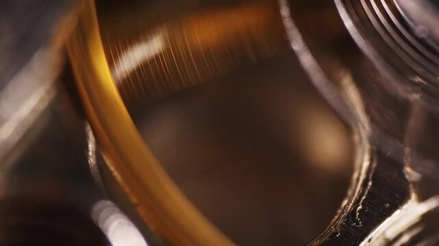Slow motion of a circular pendulum with a spring in a clock mechanism, close-up