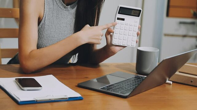 Business woman start up small business entrepreneur SME success .freelance woman working at home with Online Parcel delivery. SME and packaging deliveryconcept
