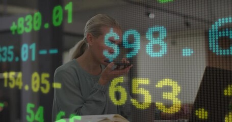 Businesswoman speaking into phone with stock market data animation overlay - Powered by Adobe