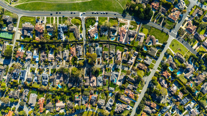 Top-down drone shot of a suburban neighbourhood in Rancho Palos Verdes, California. The image shows residential homes with green lawns, trees, and organized streets in Los Angeles County.

