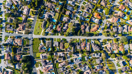 Top-down drone shot of a suburban neighborhood in Rancho Palos Verdes, California. The image shows residential homes with green lawns, trees, and organized streets in Los Angeles County.