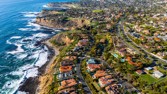 Aerial photo of luxury coastal homes along the scenic cliffs of Rancho Palos Verdes, California. The image captures elegant residential properties overlooking the Pacific Ocean in Los Angeles County.
