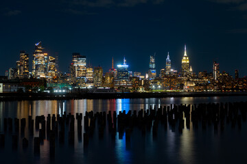 Fototapeta premium New York City at night. NYC cityscape with skyscrapers. Panoramic of New York City skyline on dusk. Manhattan skyline. New York and Hudson River. Downtown NYC. New York skyscrapers on sunset.