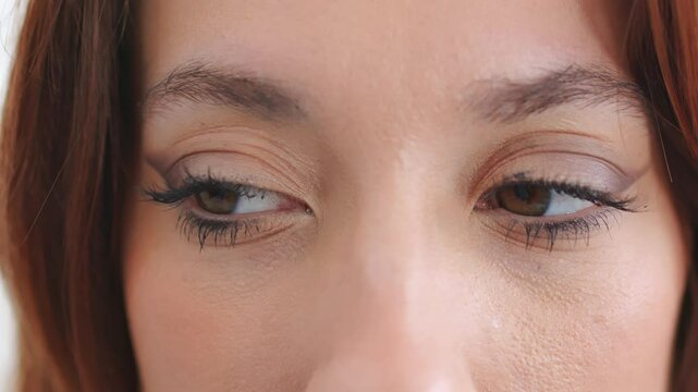 A Woman Wearing Mascara With Makeup Blinking Her Eyes. Close-up Shot