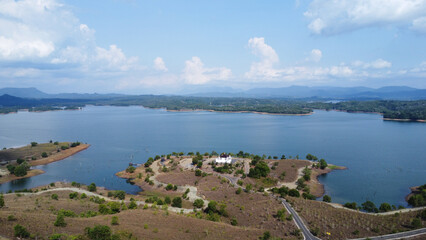Fototapeta premium Aerial view of the rocky hill tourist or bukit batu attraction in the Riam Kanan Banjarbaru reservoir, which is surrounded by wide and beautiful waters
