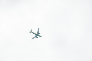 A passenger plane flying in the clouds in the sky