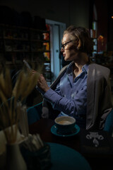 Woman in suit with books reading in restaurant