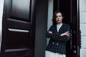 A woman in a dress and a business jacket opened the doors