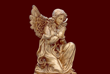 Little angel with wings on his knees on a retro background	
