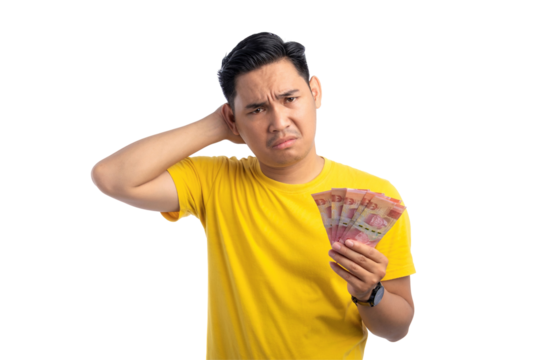 Handsome young Asian man holding money, scratching his head, feeling confused isolated on transparent background