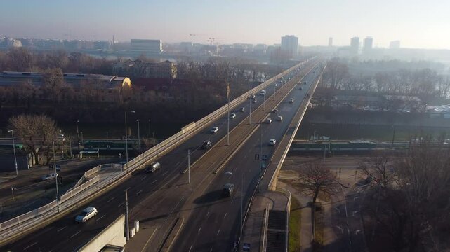 Aerial overview of Budapest highway network as cars cross &Aacute;rp&aacute;d Bridge under golden light glow
