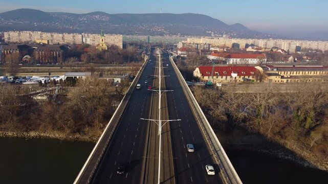 Aerial overview of straight bridge over Danube in Budapest with symmetry and urban flow