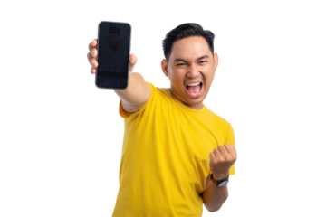 Excited young Asian man celebrating and showing smartphone screen with a victory gesture isolated on transparent background