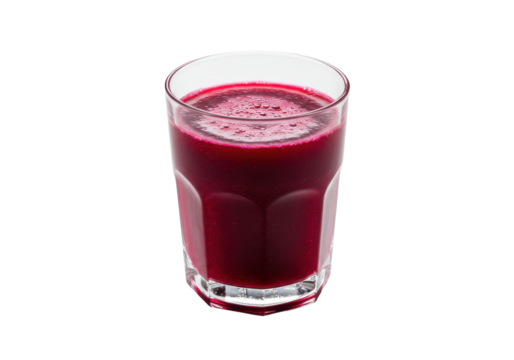 Freshly poured vibrant beetroot juice in a clear glass, isolated on white background