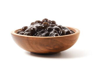 Brown sugar pearls bubble in wooden bowl isolated on white background
