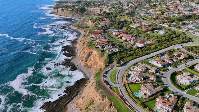 Aerial photo of luxury coastal homes along the scenic cliffs of Rancho Palos Verdes, California. The image captures elegant residential properties overlooking the Pacific Ocean in Los Angeles County.