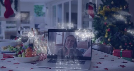 Laptop on festive table with digital data animation overlaying screen - Powered by Adobe