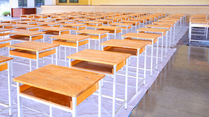 A large group of the old student desks that have been renovated to make them last longer.