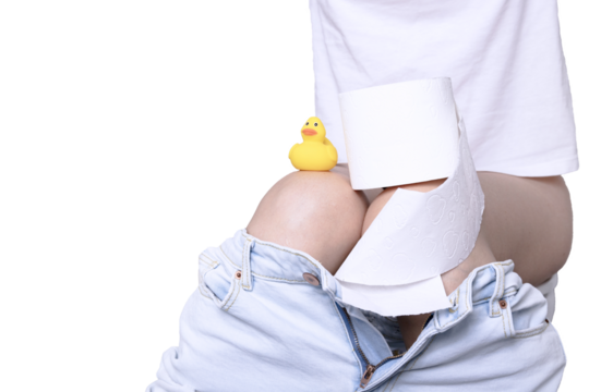 A woman with diarrhea pees in a toilet with a roll of white paper and a yellow duck in her hand. Copy space.