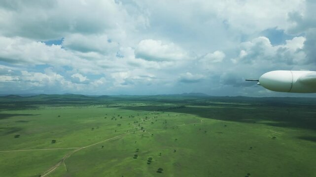 Wing view from flight Cessna 208b caravan from Zanzibar to Tanzania looking across vast landscape