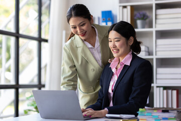 Woman employee is discussing paperwork with colleagues in the office.