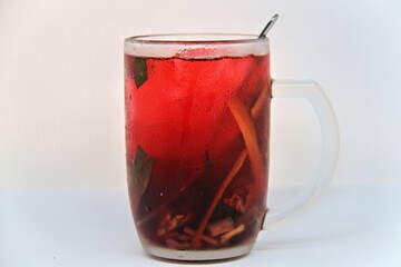 Chilled version of Wedang Uwuh, a traditional Indonesian herbal drink made with ginger, cinnamon, cloves, and lemongrass. Served cold with a vibrant red color and refreshing taste.