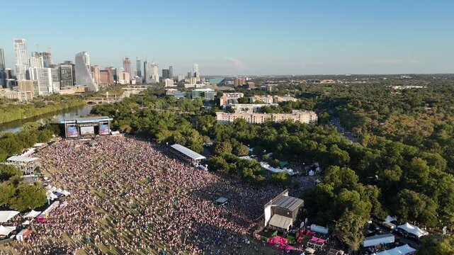 2024 Austin City Limits Music Festival crowd at Zilker Park with Austin, Texas skyline 4K Aerial Drone Video