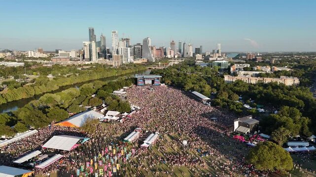 2024 Austin City Limits Music Festival crowd at Zilker Park with Austin, Texas skyline 4K Aerial Drone Video